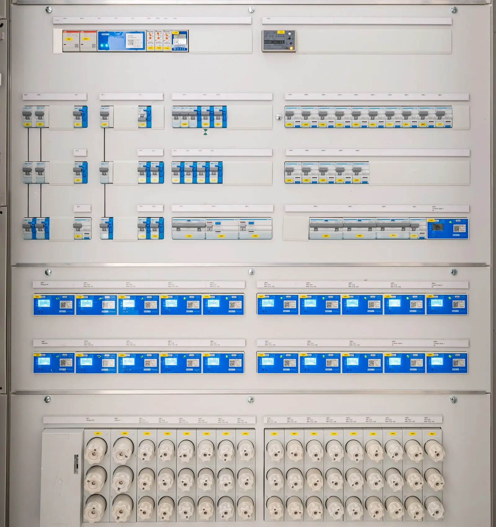 Distribution board with rows of breakers and printed circuit labels
