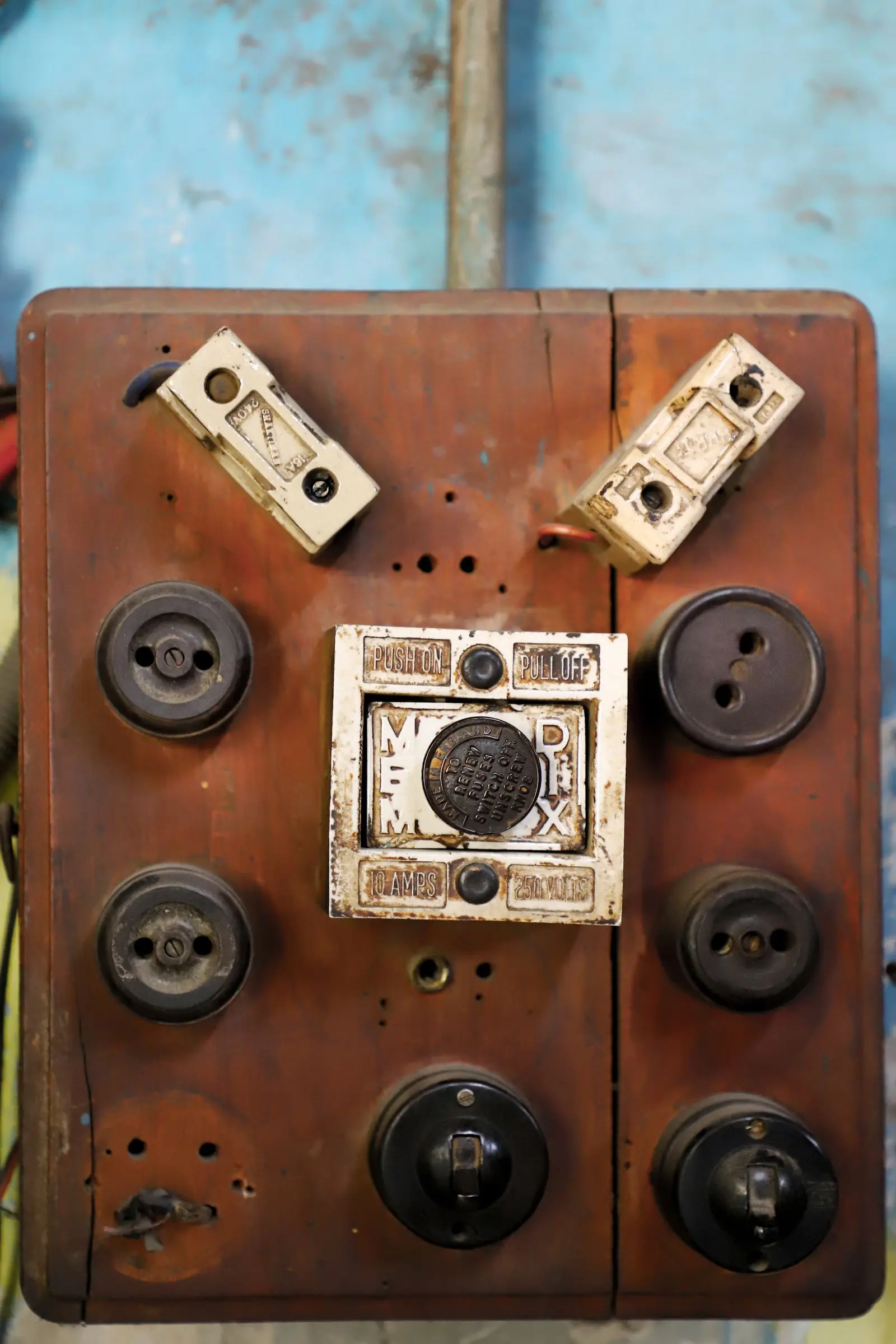 Very old switches and sockets screwed to a wooden board