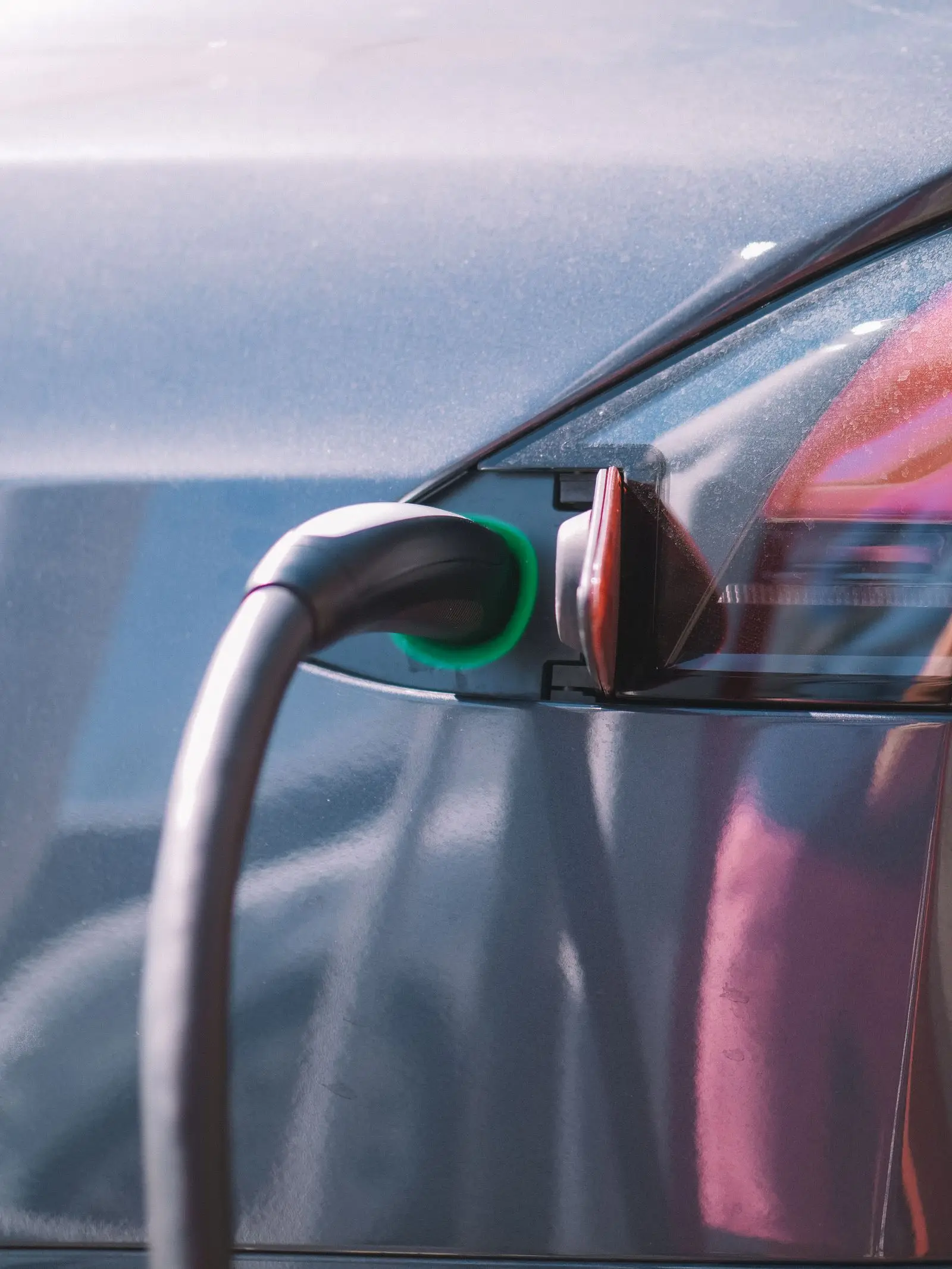 Charging connector plugged into the charge port of an electric car