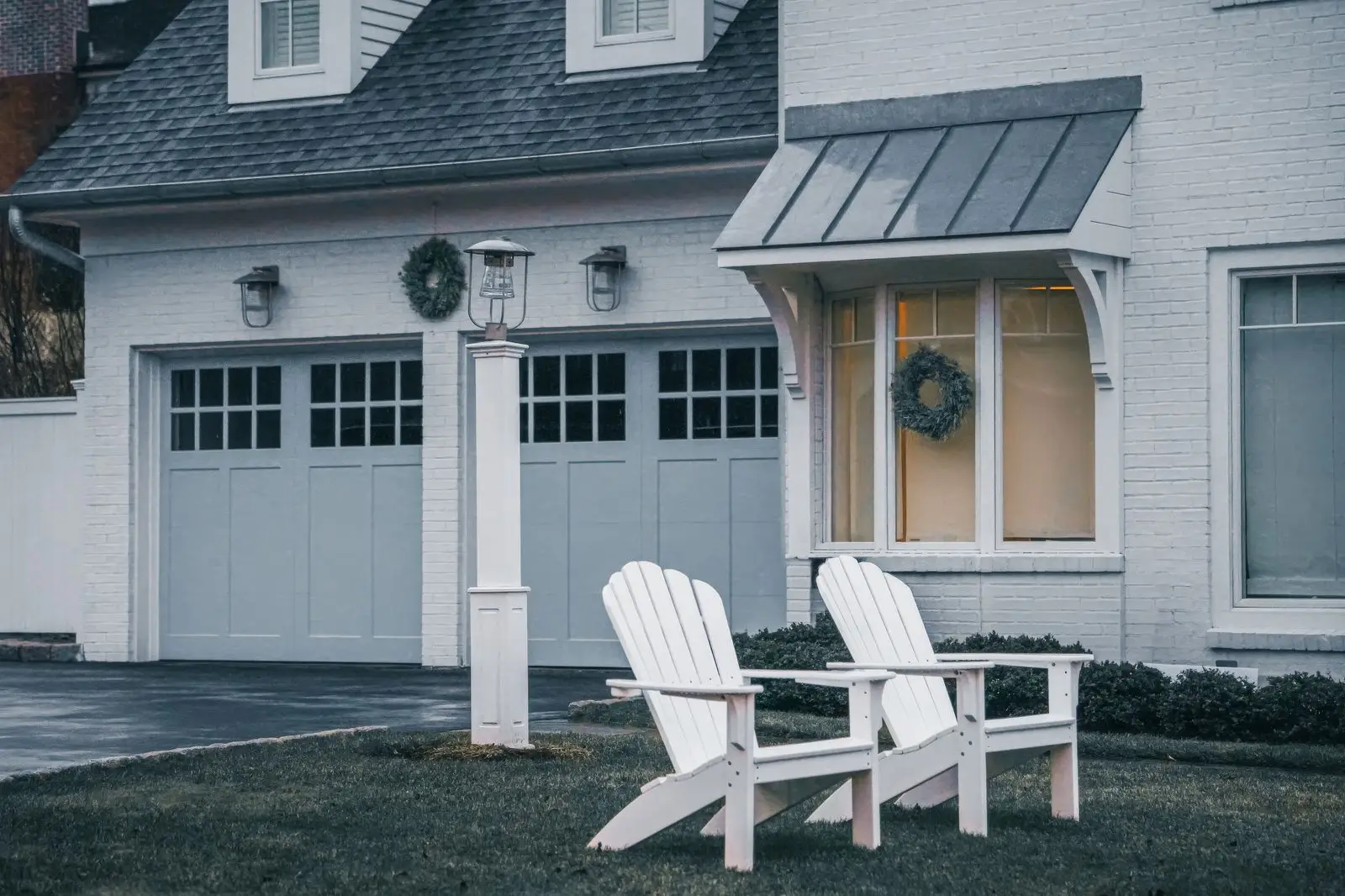 Front of a suburban house with two garage doors and a driveway