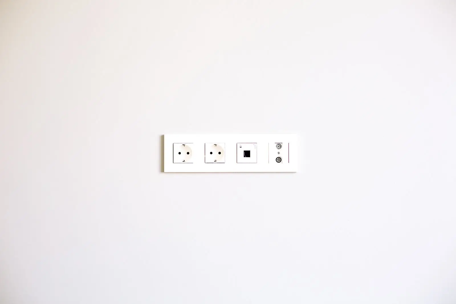 Row of newly fitted outlets on a plain white wall